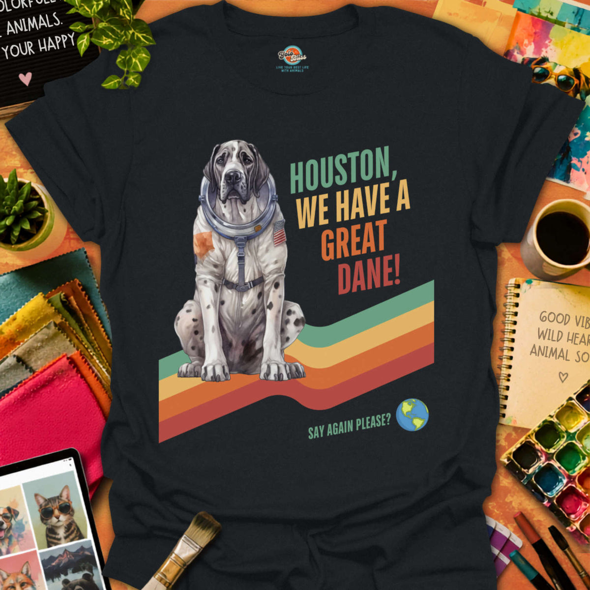 Black t-shirt with a dog in a space suit graphic and text on a colorful background