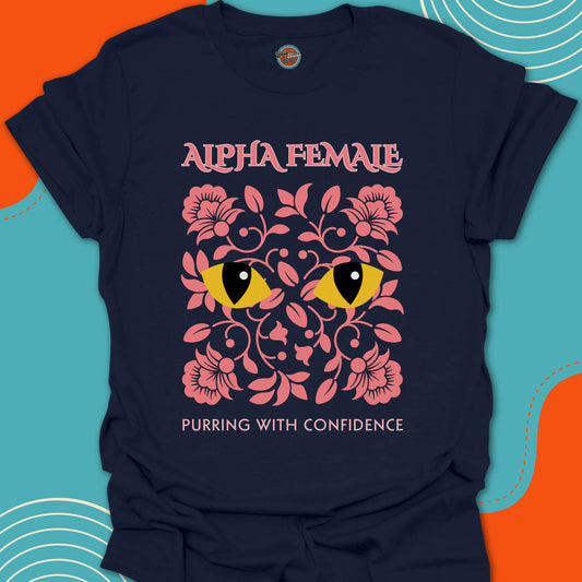 Navy t-shirt with pink floral design and rounded yellow cat eyes graphic along with "alpha female purring with confidence" text