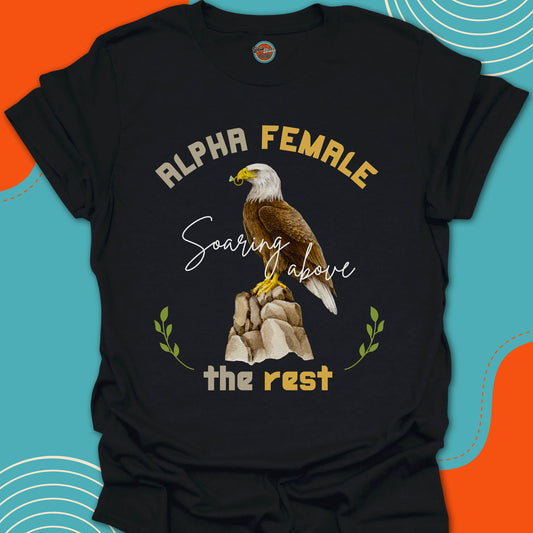 Black t-shirt with an eagle on a rock with a diamond ring in his beak graphic and "alpha female, soaring above the rest" text 