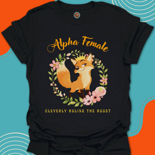 Black t-shirt with a cute fox wearing a golden crown on her head and floral circular arrangement graphic and "alpha female cleverly ruling the roost" text on a colorful background