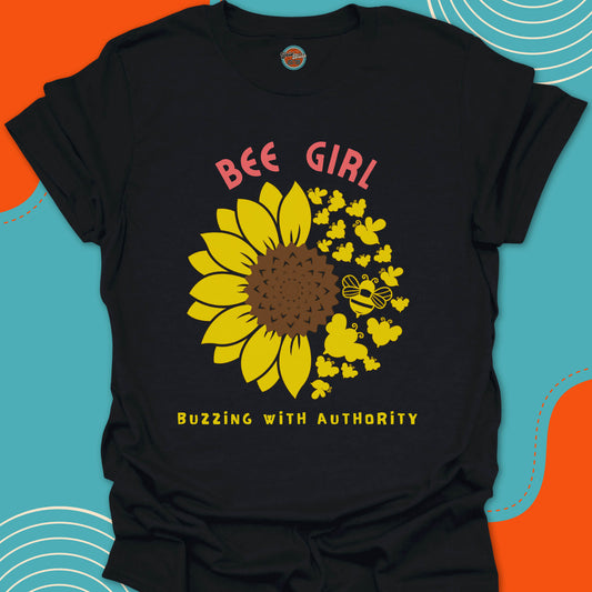 Black t-shirt with a yellow sunflower and bees circular graphic and "Bee Girl buzzing with authority" text