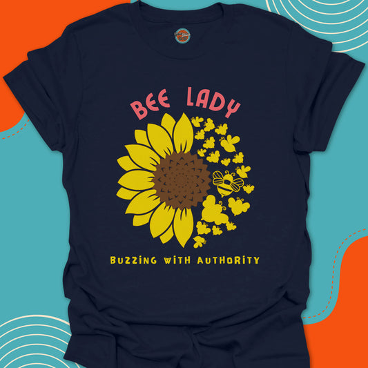 Navy blue t-shirt with a yellow sunflower and bees circular graphic and "bee lady, buzzing with authority" text