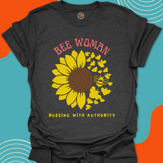 Dark gray t-shirt with a yellow sunflower and bees circular graphic and "bee woman, buzzing with authority" text