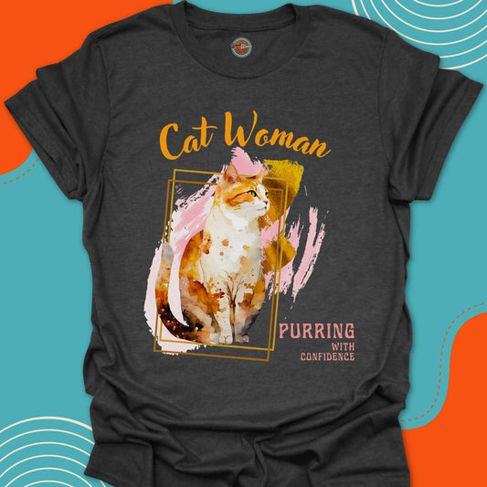 Dark Grey t-shirt with a orange and white cat graphic on a painted background design and "Cat Woman,  purring with confidence" text