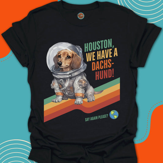 Black t-shirt with a dachshund in an astronaut suit graphic and text on a stripped colorful background
