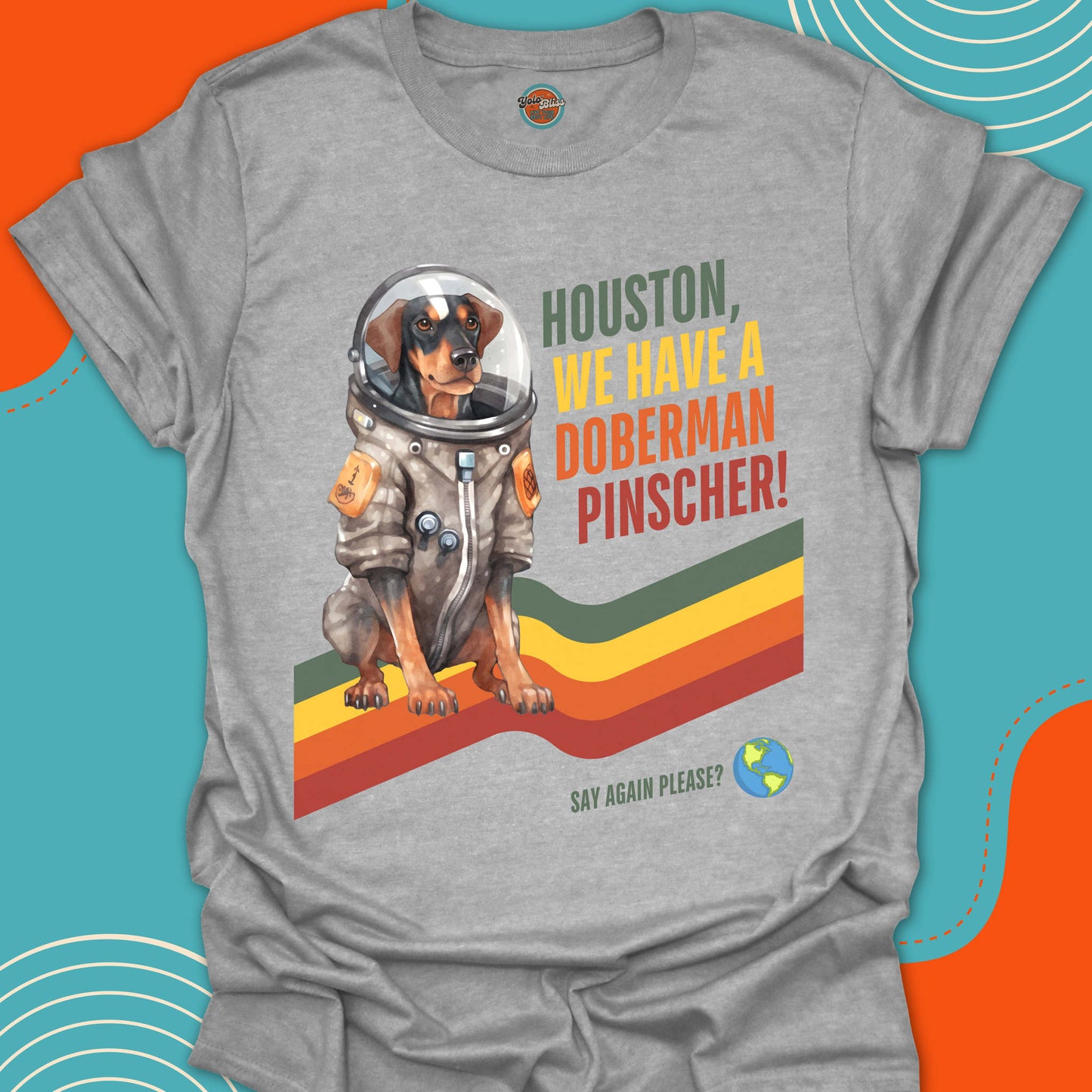 Gray t-shirt with a doberman pinscher in an astronaut suit graphic and text on a colorful background