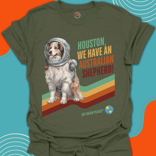 Green t-shirt with an Australian Shepherd in an astronaut suit graphic and text on a colorful background