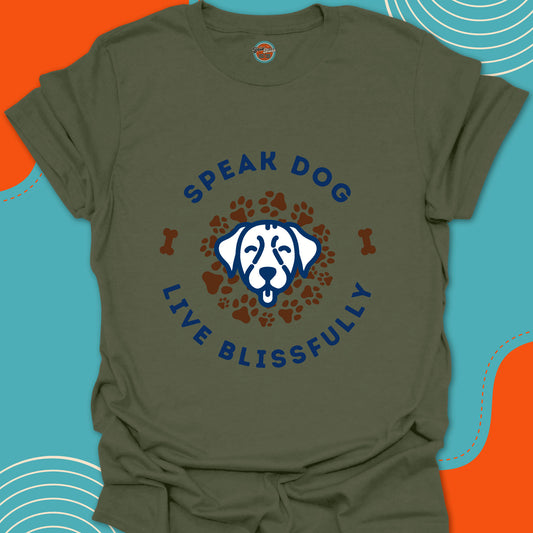 Green t-shirt with a happy dog-themed graphic on a brown paw prints  background and blue text "speak dog"