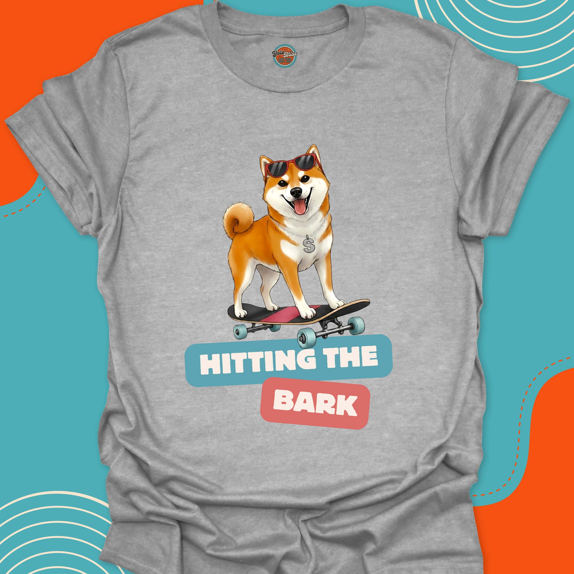 Gray t-shirt with a dog on a skateboard graphic and text 'Hitting the Bark'