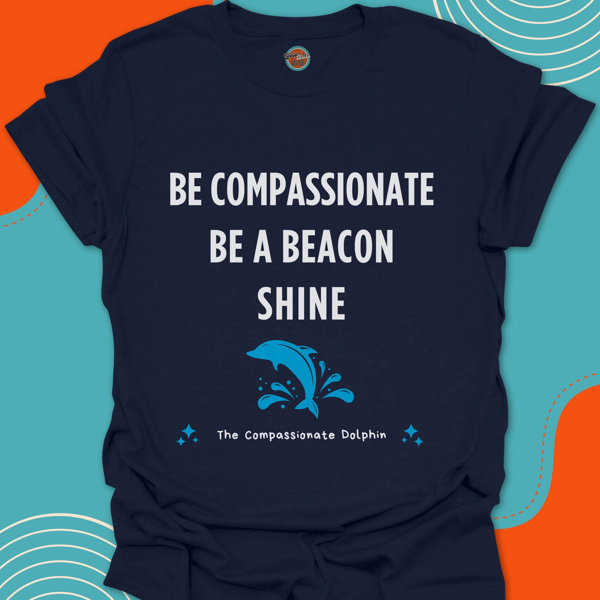 Navy blue t-shirt with motivational text "Be compassionate, be a beacon, shine"and jumping blue dolphin in the sea graphic