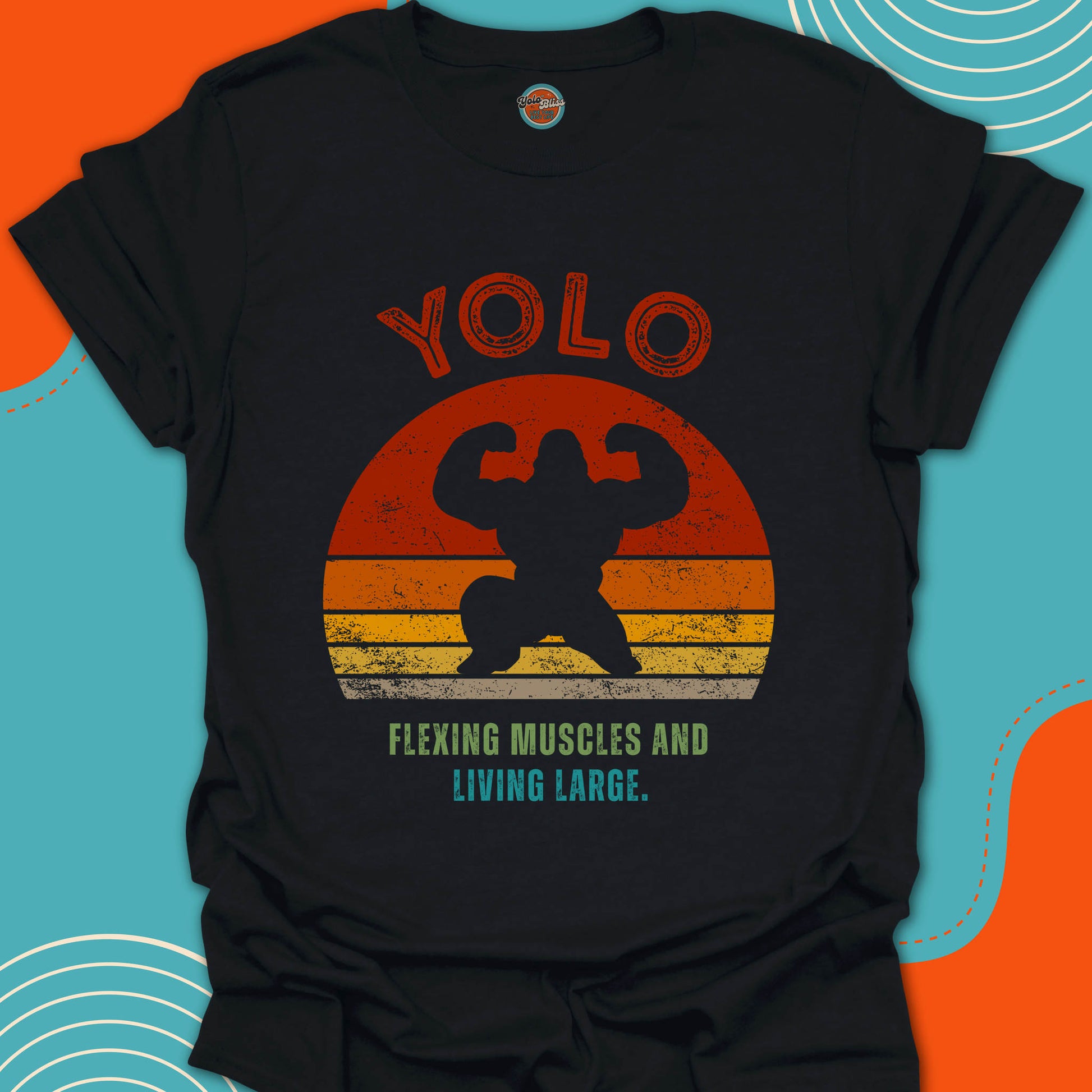 Black t-shirt with "YOLO Flexing Muscles and Living Large" text and a large gorilla silhouette graphic design on a fashionable sunset background
