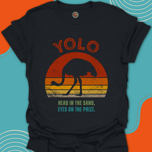 Black t-shirt with 'YOLO' and "head in the sand" text design featuring a silhouette of an ostrich on a colorful sunset background