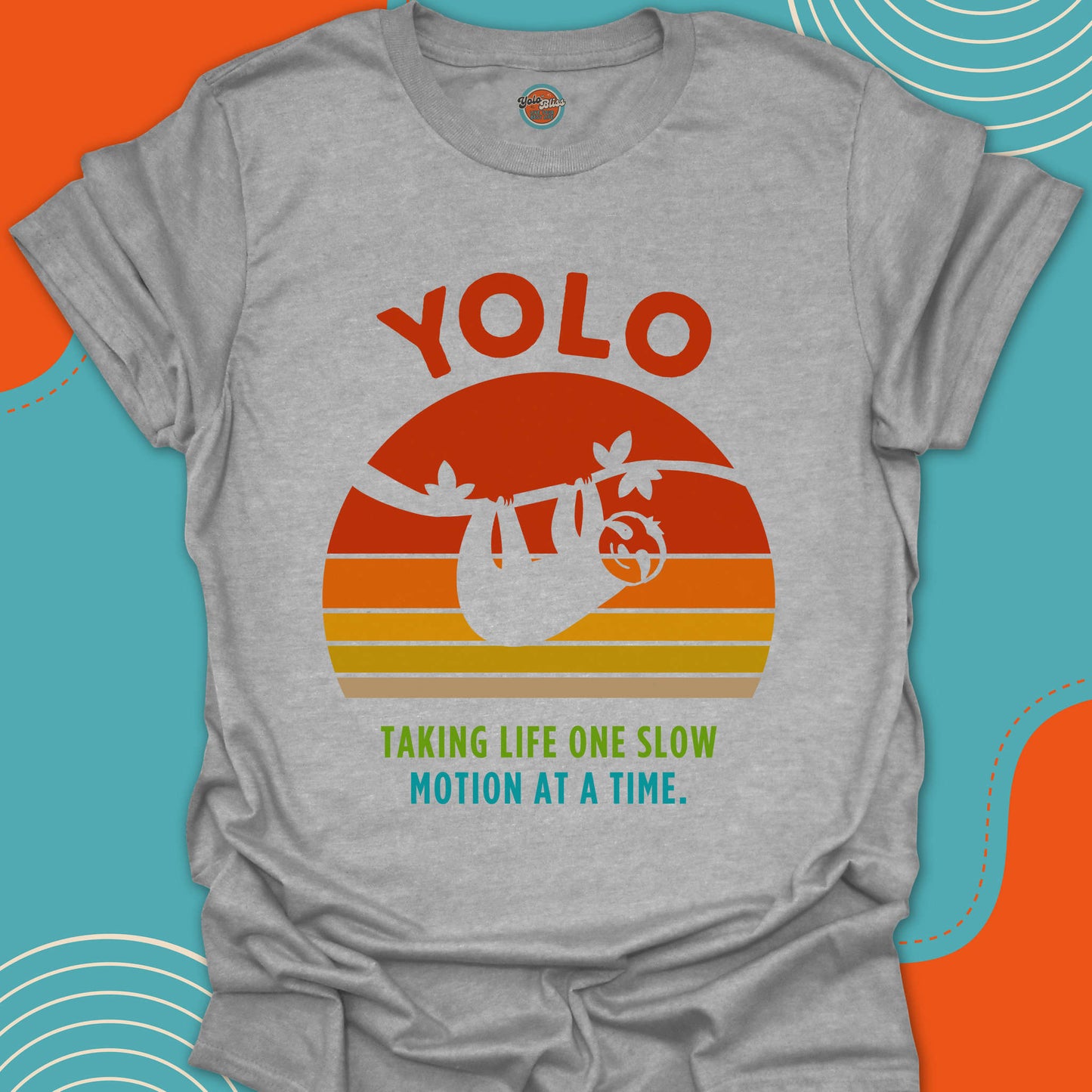 Gray t-shirt with 'YOLO' and sloth graphic on a colorful background